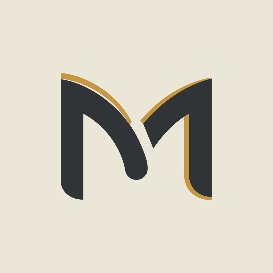 Lettre M du logo Manemaykane, anthracite et dorée : identité visuelle et supports de communication